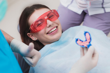 doctor orthodontist performs a procedure for cleaning teeth