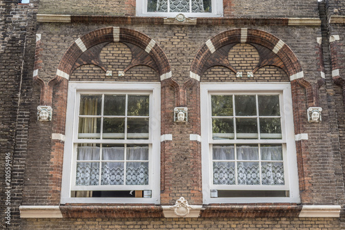 Traditional Dutch White Lace Curtains Behind Two Ancient Windows Traditional Dutch White Lace Curtains Behind Two Ancient Windows