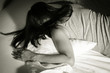© peerayot - Woman crying on bed,black and white color.