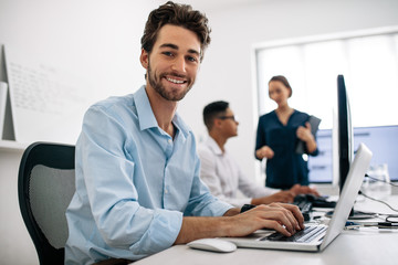 Application developers working on computers in office