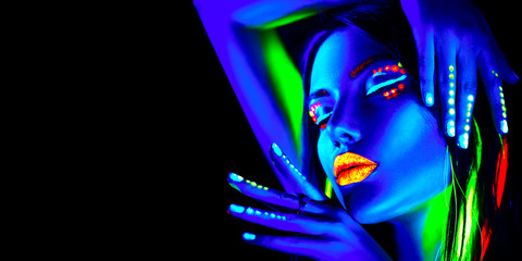 Wall Mural - Fashion model woman in neon light, portrait of beautiful model girl with fluorescent makeup, Body art design in UV, painted face, colorful make up, over black background