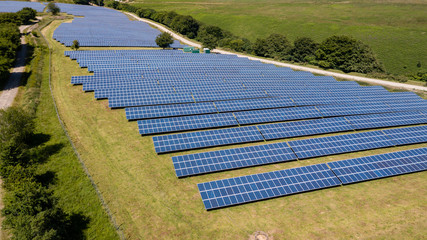 Wall Mural - Aerial drone view of a large mountain top solar power farm