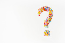 Question Mark On A  Background From Multi-colored Confetti, From Pieces Of Color Paper.