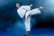 © FS-Stock - White Karate Fighter Isolated On Black with smoke effect