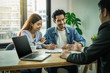 © THANANIT - Sale representative present the price and conditon to Asian young couple when signing the contract house purchase or rental on the working space table in new place,Moving and House Hunting concept