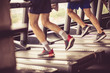 © Mladen - People exercising together on treadmill.