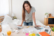 © weedezign - Asian woman freelancer upset with work problem with laptop on mess table.work at home concept.stress working.