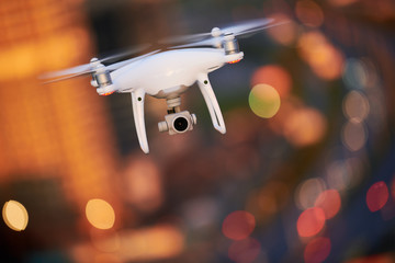 Wall Mural - drone quadcopter with digital camera hovering over city
