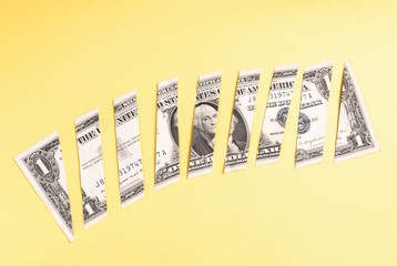 Wall Mural - Dollar banknote cut into pieces on yellow