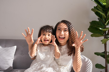 Wall Mural - Happy young mother with daughter at home