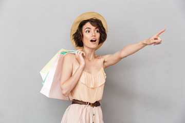 Wall Mural - Portrait of a joyful young woman in summer hat