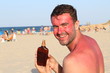 Extremely sunburned man holding suntan accelerator 
