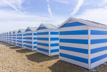 Blue And White Striped Beach Huts At The Seaside