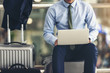 © Fluky - Asian businesspeople are using laptop to check their flights at the airport.focus on laptop.