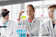 Education, Science And Children Concept - Kids With Test Tubes Studying Chemistry At School Laboratory