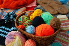 Balls Of Yarn For Knitting In The Basket. Lots Of Colorful Yarn Balls In A Wicker Basket. Knitting Clothes As A Kind Of Needlework.