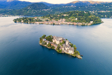 The very suggestive and romantic island of San Giulio in Orta lake, Piedmont, Italy. Aerial view.