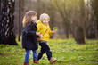 © Maria Sbytova - Cute little children playing together in sunny spring park