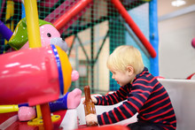 Happy Little Boy Having Fun In Amusement In Play Center