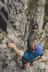 Male Alpinist Climbing a Rock