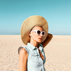 Wall Mural - Girl in fashion accessories. Hat and sunglasses. Beach mood