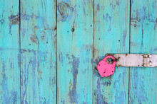 Iron Heart Lock Hanging On Antique Rustic Teal Blue Door; Old Wooden Background With Love Concept And Copy Space