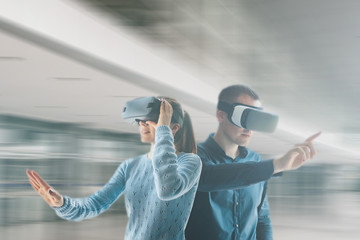 Wall Mural - A young woman and a young man in virtual reality glasses.The concept of modern technologies and technologies of the future. VR glasses.