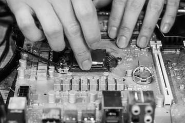 close up repairman work , mainboard , motherboard in cpu computer . component of electronic circuit hardware , chipset