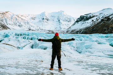 adventurous man walking on a glacier in iceland