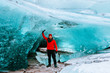 adventurous man walking on a glacier in iceland