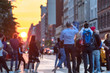 People standing in the middle of 23rd street photographing the sunset in Manhattan, New York City
