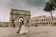 © BGStock72 - Young wedding couple by Arch of Constantine in Rome