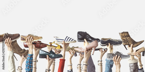 Pinturas sobre lienzo  Hands holding different shoes on isolated background