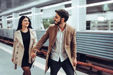 Wall Mural - Young romantic couple in subway