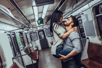 Wall Mural - Young romantic couple in subway