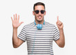 © Krakenimages.com - Handsome young man wearing headphones showing and pointing up with fingers number six while smiling confident and happy.