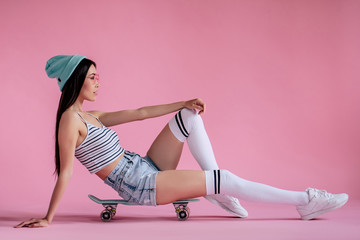 Wall Mural - Young girl on pink background