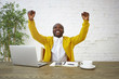 © Anatoliy Karlyuk - Happy ecstatic young fashionable dark skinned businessman smiling excitedly and raising clenched fists, being overjoyed, celebrating successful meeting, negotiations, good deal, contract or victory
