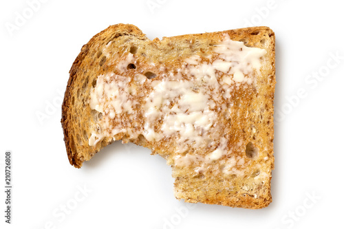 Cuadros en Lienzo Buttered slice of whole wheat toast isolated on white from above