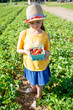 © Sarah Rypma - Smiling girl in hat holding strawberries