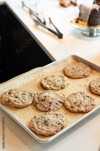 Valokuva Freshly baked chocolate chip cookies on parchment line baking sheet with space f
