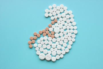 Wall Mural - Kidney made of pills on blue background. World Kidney Day concept