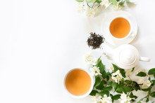 Green Jasmin Tea And Jasmine Flowers, Cup Of Green Tea On White. Top View. Teatime.