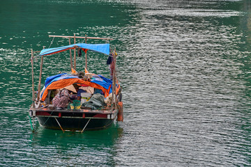 Wall Mural - Ha Long Bay , Vietnam-29 November 2014:Fishing boat in Ha long Bay, Panoramic view of sunset in Halong Bay, Vietnam, Southeast Asia,UNESCO World Heritage Site