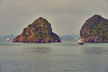 Wall Mural - Halong bay boats, Vietnam Panoramic view of sunset in Halong Bay, Vietnam, Southeast Asia,UNESCO World Heritage Site, Poor lighting conditions