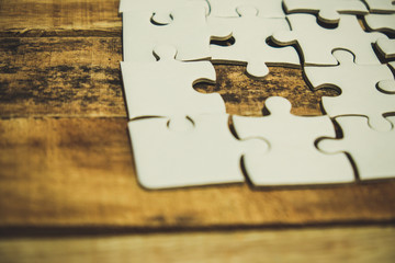 close up of puzzle pieces on table, business and connection concept