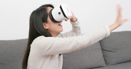 Sticker - Woman looking though VR device at home