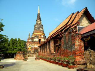 Ancient Buddhist temple with pagoda and big Buddha statue in Thailand.