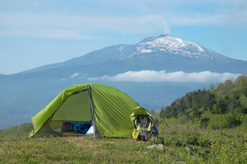 green tent on meadow in front of etna volcano, sicily