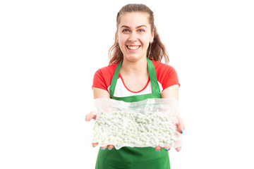 Poster - Cheerful female supermarket employee offering product.